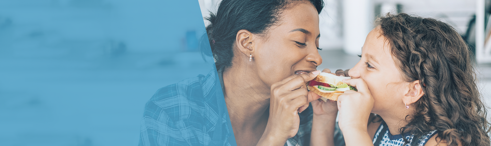 Stay Healthy banner displaying a women and child taking a bite of the same sandwich
